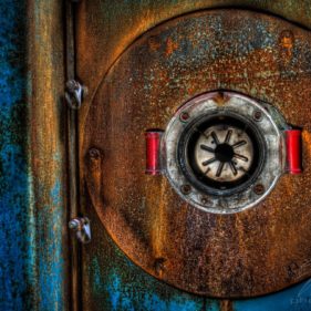 The rusty door of one of the remaining boilers of the Clinique Du Diable.